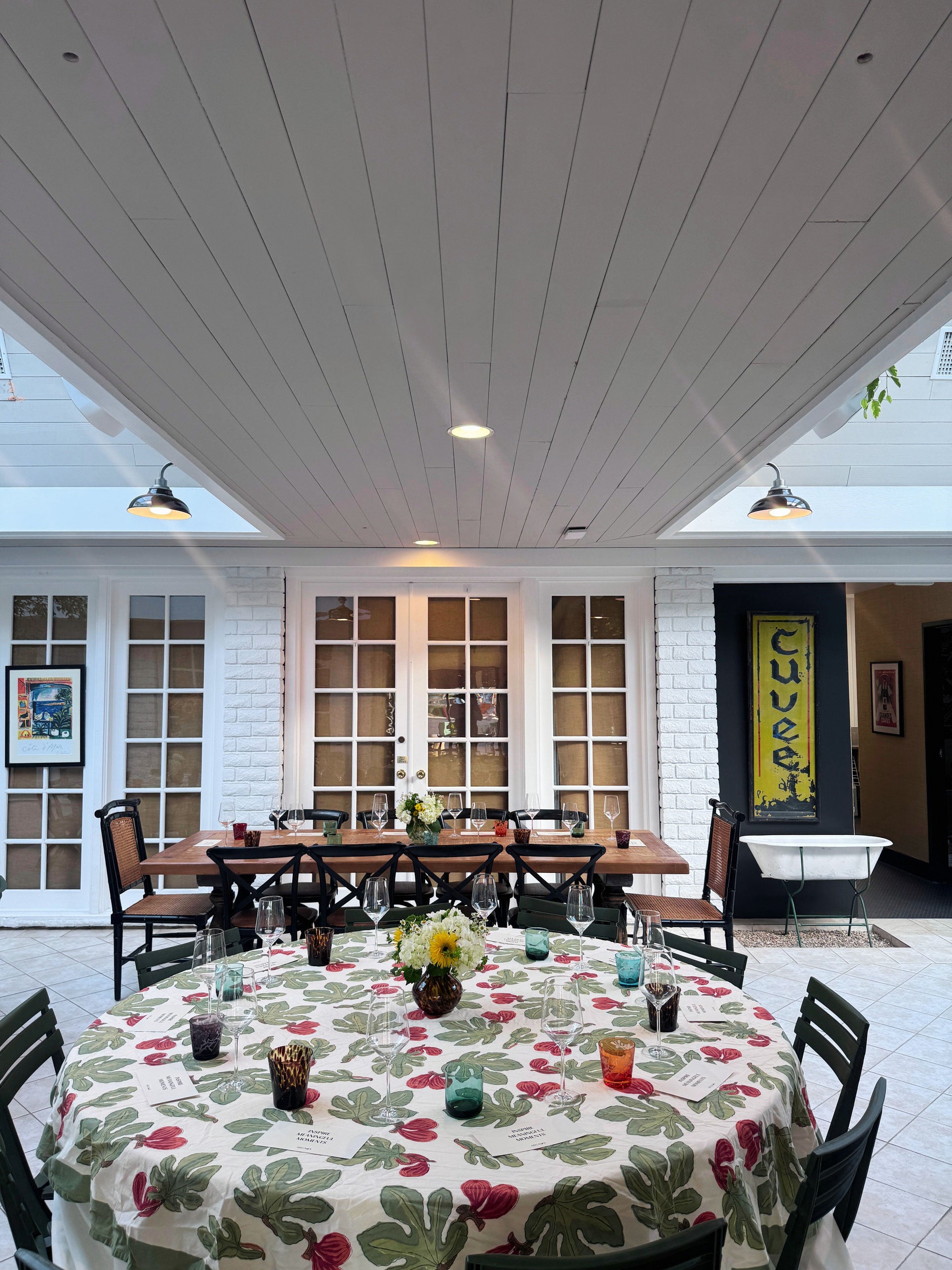 Argaux venue in Costa Mesa, dining area with tables and chairs inside a building with white walls and ceiling.